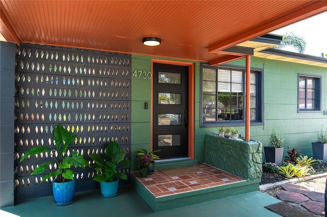 entrance to property featuring concrete block siding
