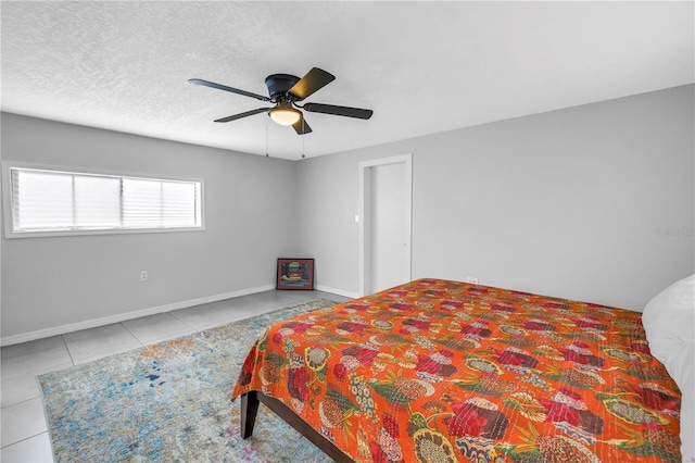 bedroom with baseboards, ceiling fan, and tile patterned flooring