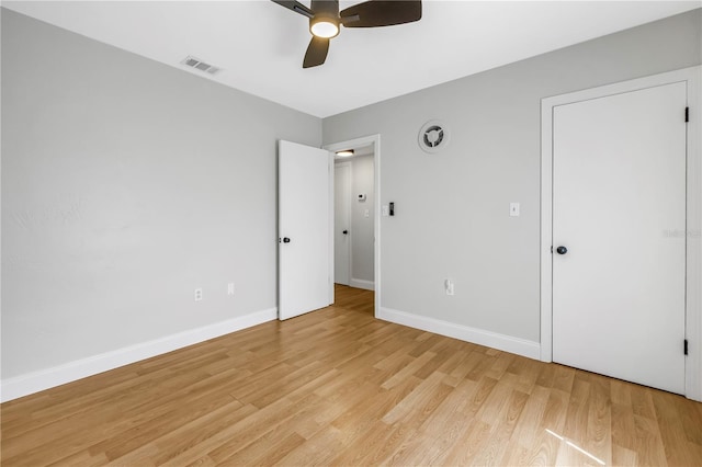 unfurnished bedroom with baseboards, visible vents, a ceiling fan, and light wood finished floors