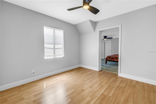 unfurnished bedroom with baseboards, light wood-type flooring, and a ceiling fan