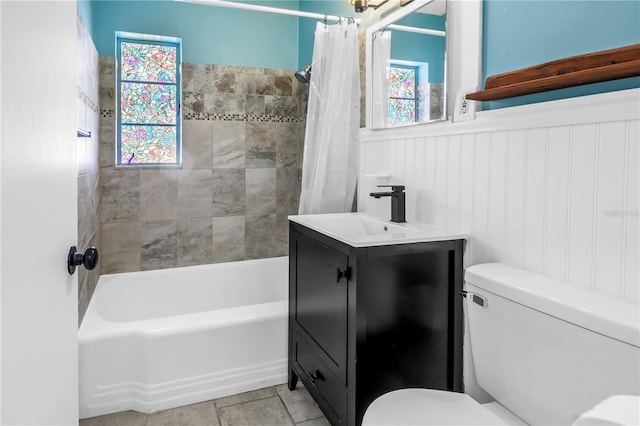 full bathroom with shower / bath combination with curtain, vanity, toilet, and a wainscoted wall