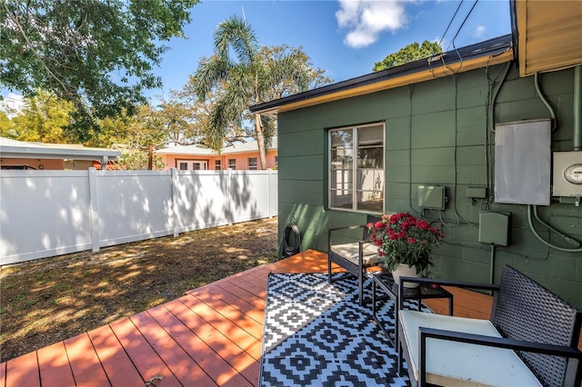wooden terrace featuring fence