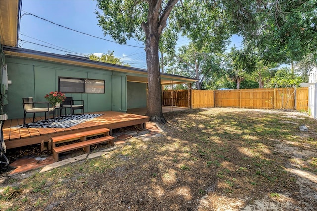 view of yard featuring a wooden deck and a fenced backyard
