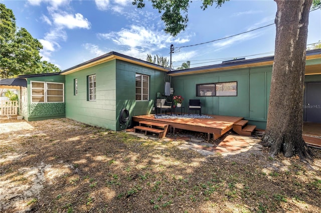 back of property featuring a wooden deck