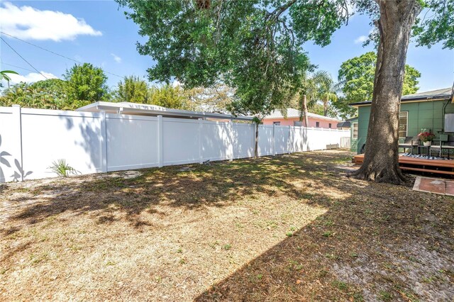 view of yard with a deck and a fenced backyard