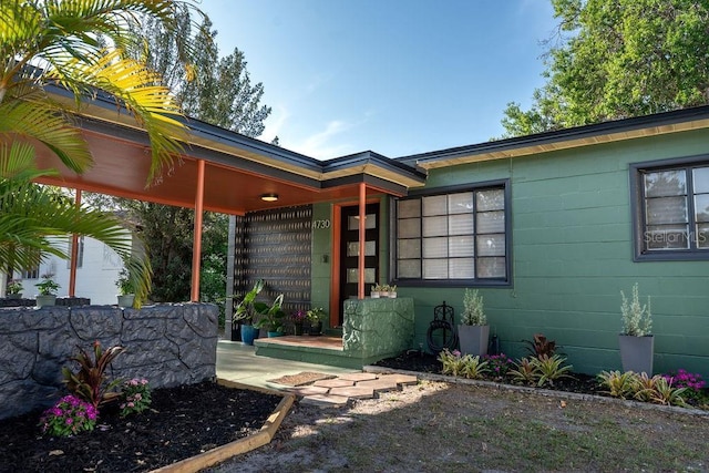 doorway to property featuring concrete block siding