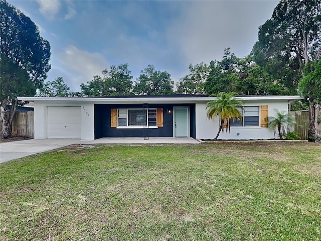 ranch-style home featuring stucco siding, a front yard, fence, an attached garage, and driveway