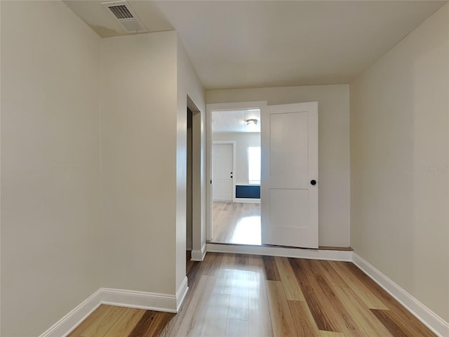 interior space featuring visible vents, baseboards, and wood finished floors
