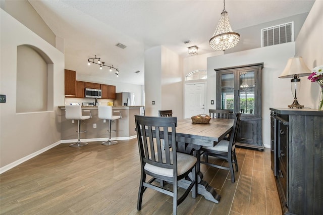 6006 Chellas Ct, Lutz, FL 33558 - dining room with baseboards, visible vents, and wood finished floors