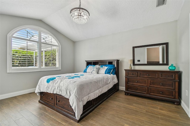 6006 Chellas Ct, Lutz, FL 33558 - bedroom featuring an inviting chandelier, baseboards, wood finished floors, lofted ceiling, and visible vents