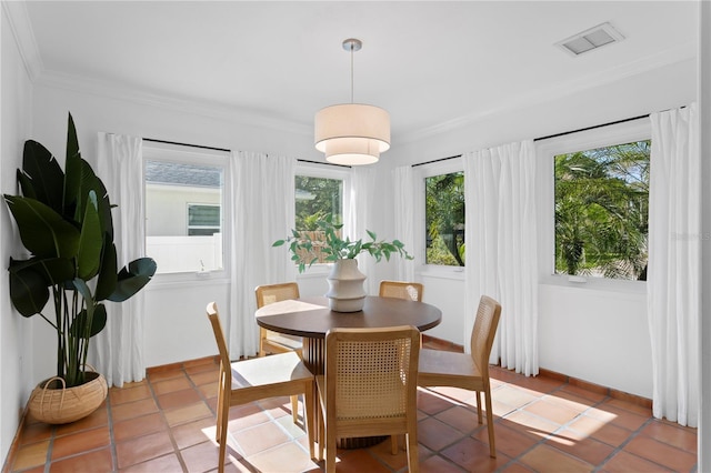 dining room featuring visible vents, ornamental molding, and light tile patterned floors