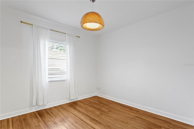 empty room featuring baseboards and light wood-style floors