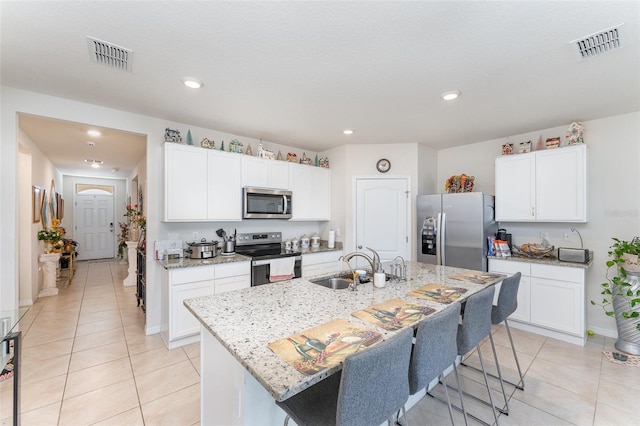 947 Serchio St, Haines City, FL 33844 - kitchen with appliances with stainless steel finishes, light tile patterned flooring, a sink, and visible vents