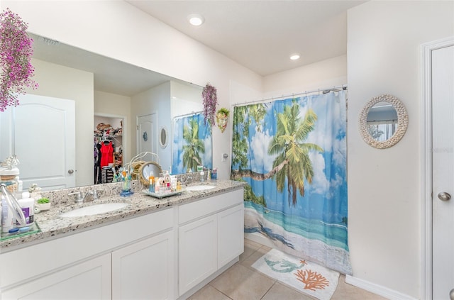 947 Serchio St, Haines City, FL 33844 - full bathroom featuring a sink, a spacious closet, double vanity, and tile patterned flooring