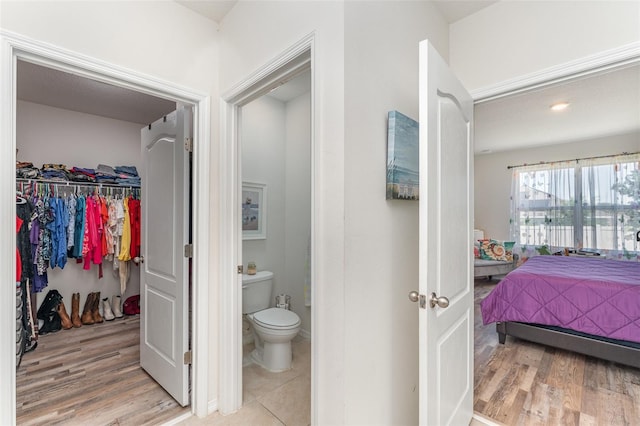 947 Serchio St, Haines City, FL 33844 - ensuite bathroom with toilet, ensuite bath, and wood finished floors