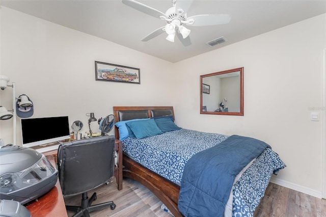 947 Serchio St, Haines City, FL 33844 - bedroom with visible vents, baseboards, a ceiling fan, and wood finished floors