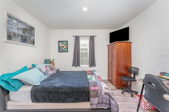 947 Serchio St, Haines City, FL 33844 - bedroom featuring baseboards and wood finished floors