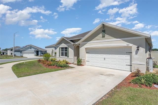 947 Serchio St, Haines City, FL 33844 - view of front of house featuring concrete driveway, stucco siding, and a garage