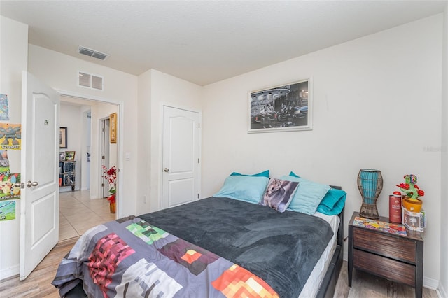 947 Serchio St, Haines City, FL 33844 - bedroom featuring visible vents, light wood-style flooring, and baseboards