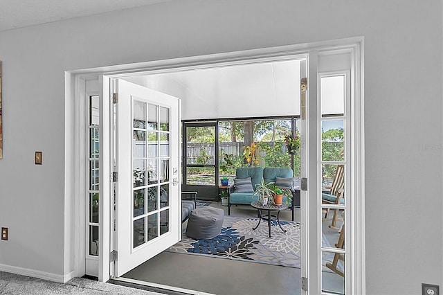 doorway to outside with baseboards
