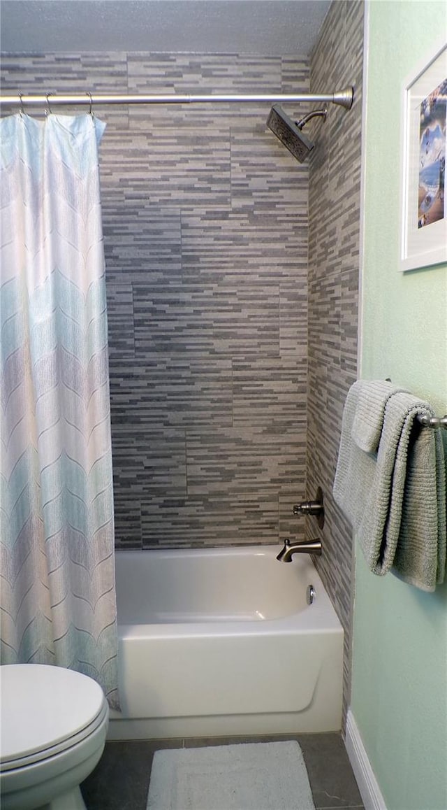 bathroom featuring tile patterned floors, shower / bathtub combination with curtain, baseboards, and toilet