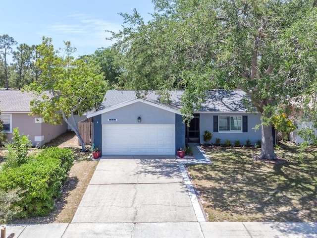ranch-style house featuring roof with shingles, an attached garage, stucco siding, and driveway