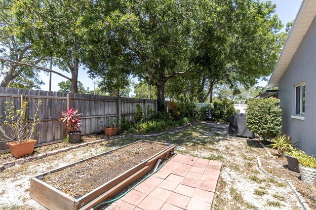 view of yard featuring a vegetable garden and a fenced backyard