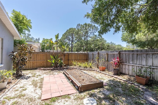 view of yard with a garden and a fenced backyard