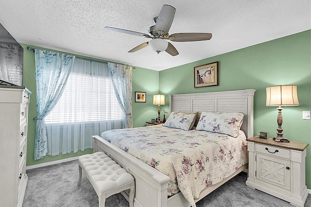 bedroom with ceiling fan, light carpet, and baseboards