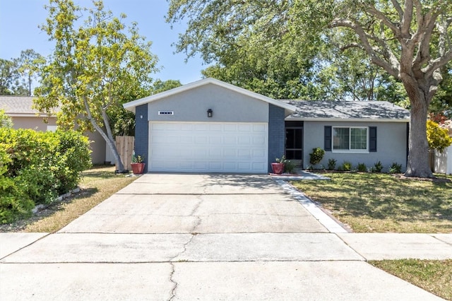ranch-style home featuring driveway, brick siding, a garage, stucco siding, and a front lawn