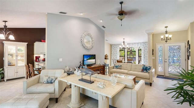 6148 Bonaventure Ct, Sarasota, FL 34243 - living area with light tile patterned floors, lofted ceiling, visible vents, and ceiling fan with notable chandelier