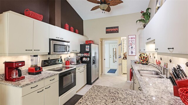 6148 Bonaventure Ct, Sarasota, FL 34243 - kitchen with a ceiling fan, a sink, decorative backsplash, light tile patterned floors, and appliances with stainless steel finishes