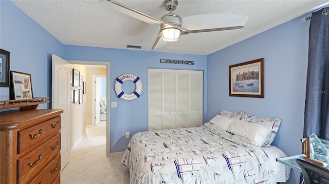 6148 Bonaventure Ct, Sarasota, FL 34243 - bedroom featuring a textured ceiling, a closet, light tile patterned floors, ceiling fan, and visible vents