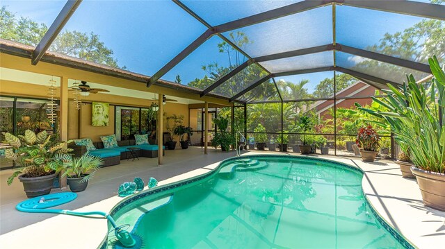 6148 Bonaventure Ct, Sarasota, FL 34243 - outdoor pool featuring a patio area, glass enclosure, a ceiling fan, and an outdoor hangout area