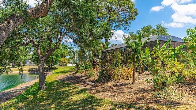 6148 Bonaventure Ct, Sarasota, FL 34243 - view of yard featuring glass enclosure and a water view