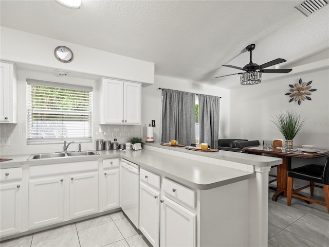 30 N Kaufman Ter, Inverness, FL 34453 - kitchen with a sink, dishwasher, a peninsula, light tile patterned floors, and visible vents
