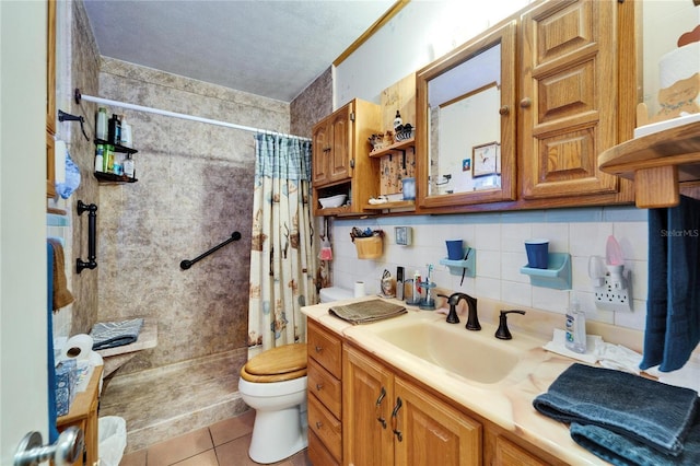 full bath with decorative backsplash, tile patterned flooring, a tile shower, vanity, and toilet