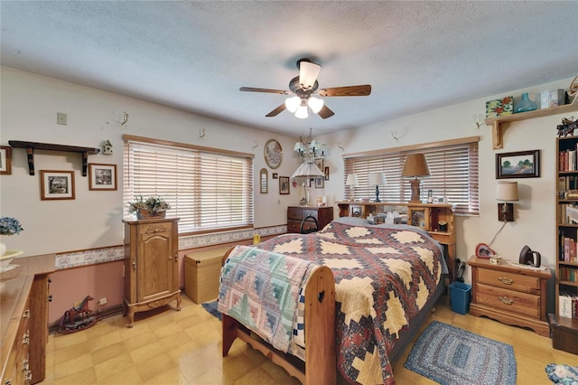 bedroom featuring a textured ceiling and light floors