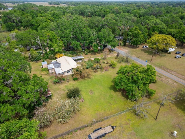 drone / aerial view with a wooded view