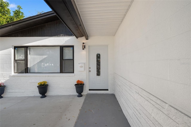property entrance featuring brick siding