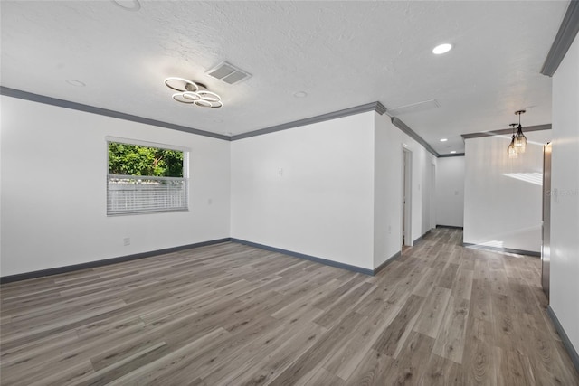 unfurnished room featuring visible vents, baseboards, wood finished floors, and recessed lighting