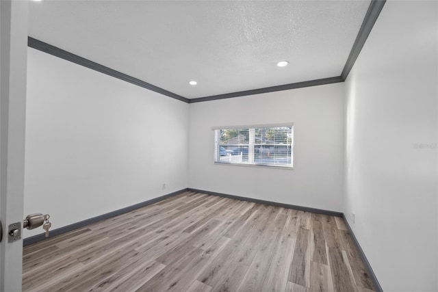 empty room featuring recessed lighting, wood finished floors, crown molding, baseboards, and a textured ceiling
