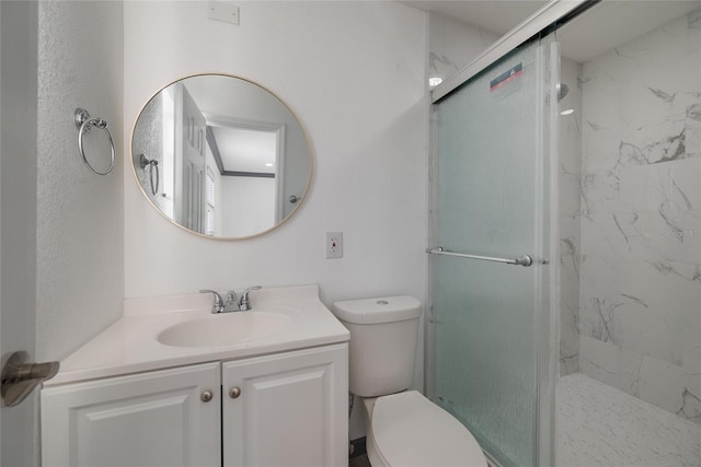 bathroom with toilet, vanity, and a marble finish shower