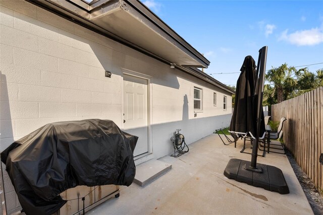 view of patio / terrace with a fenced backyard and a grill