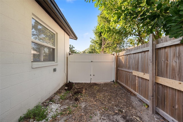 exterior space with fence and concrete block siding