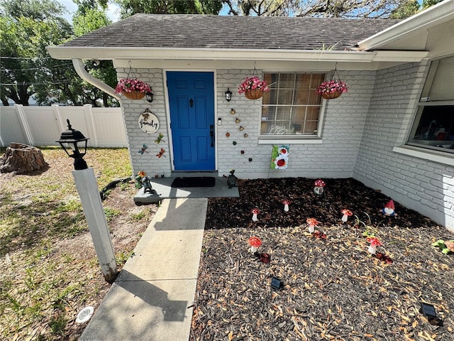 1407 College Park Ln, Tampa, FL 33612 - property entrance with fence, roof with shingles, and brick siding
