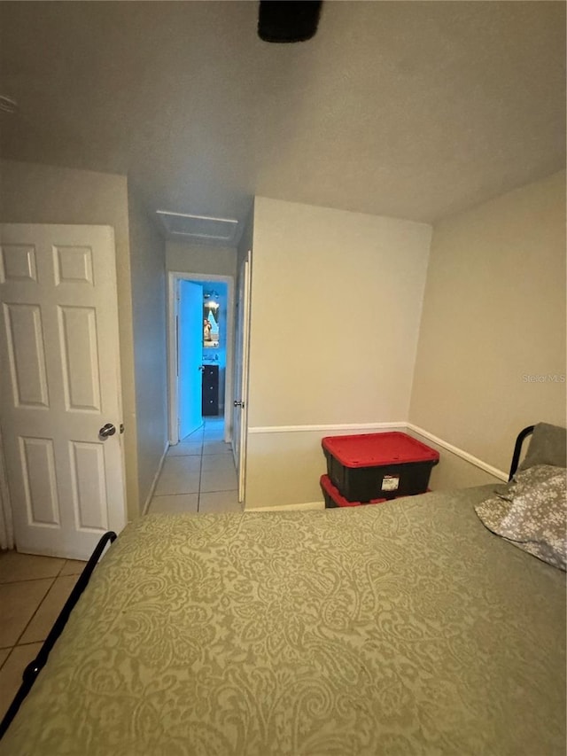 1407 College Park Ln, Tampa, FL 33612 - bedroom featuring attic access, tile patterned floors, and baseboards