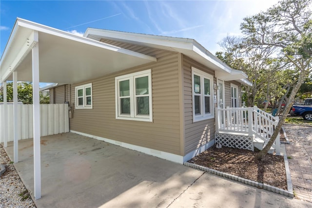 view of property exterior with fence and crawl space