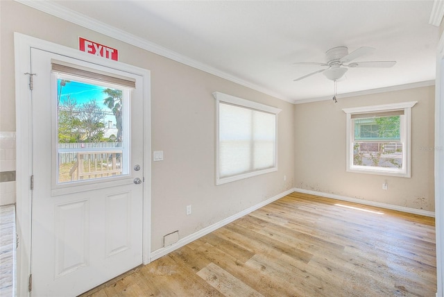 doorway with crown molding, a ceiling fan, baseboards, and light wood-type flooring