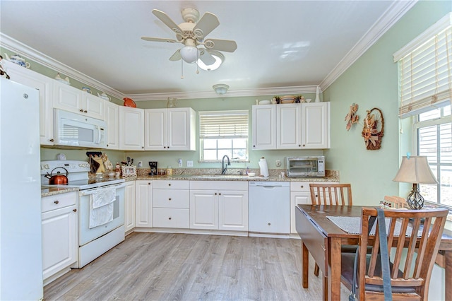 5906 Greenbriar Ct, Zephyrhills, FL 33542 - kitchen with light wood-style flooring, a sink, white appliances, and white cabinets